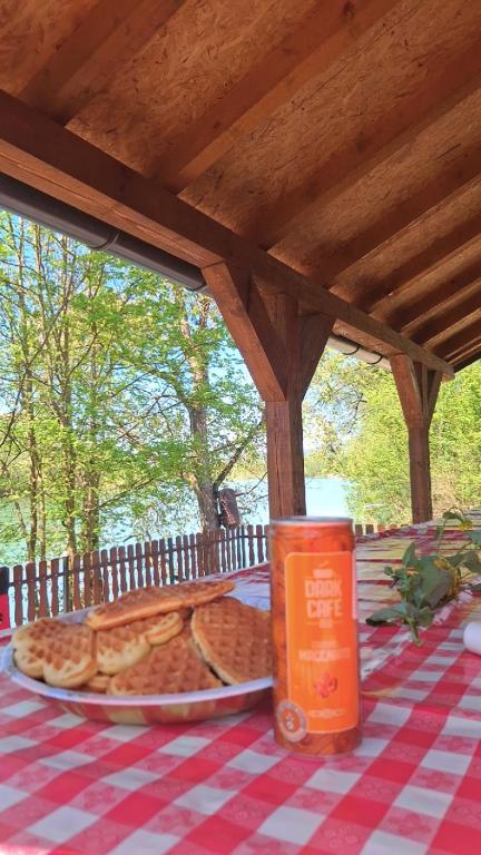 a table with a plate of food on a picnic table at Vikendica Dani in Ljubovija