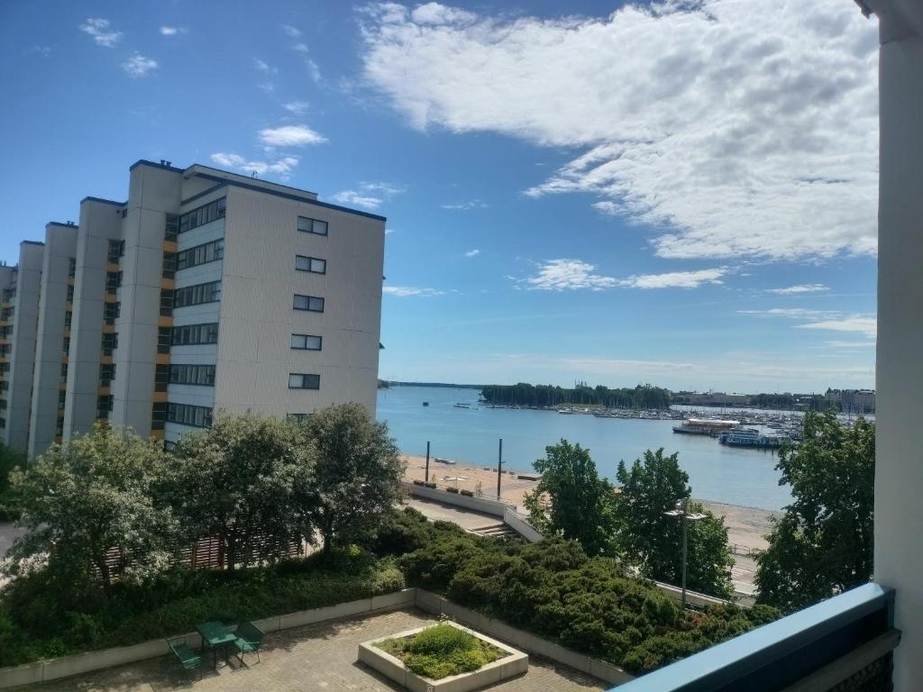 a view of the water from the balcony of a building at Seaview apartment central location Helsinki in Helsinki
