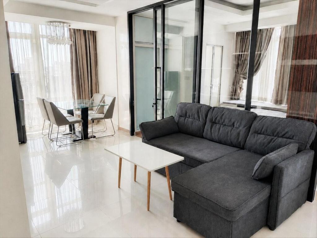 a living room with a couch and a table at Modern and quiet Condo BKK1 - Rooftop Pool in Phnom Penh