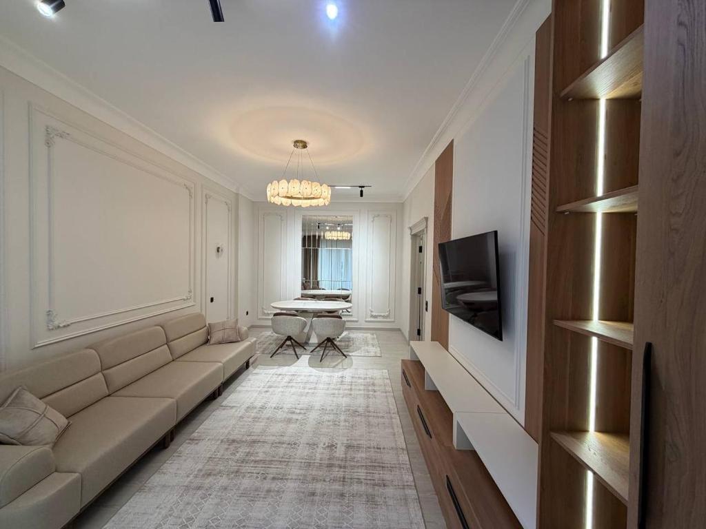 a living room with a couch and a table at Top1 Gardens Residents in Tashkent