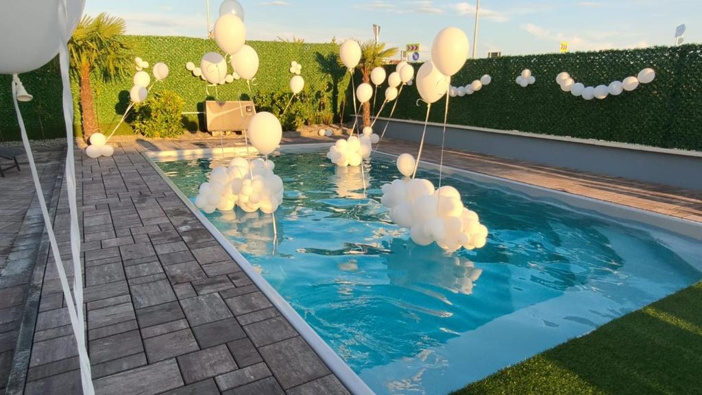 a group of white balloons in a pool at Casa Dragan in Baile Felix