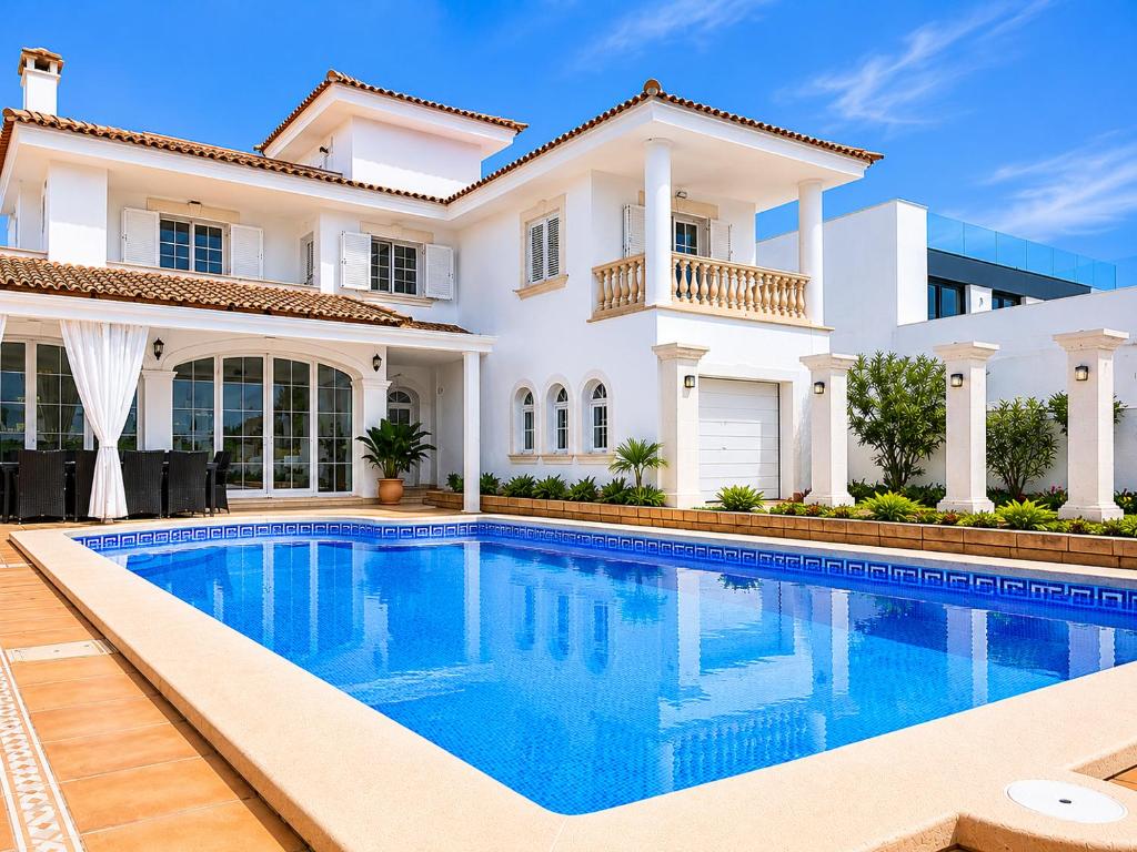 a villa with a swimming pool in front of a house at Villa Bruno in El Toro