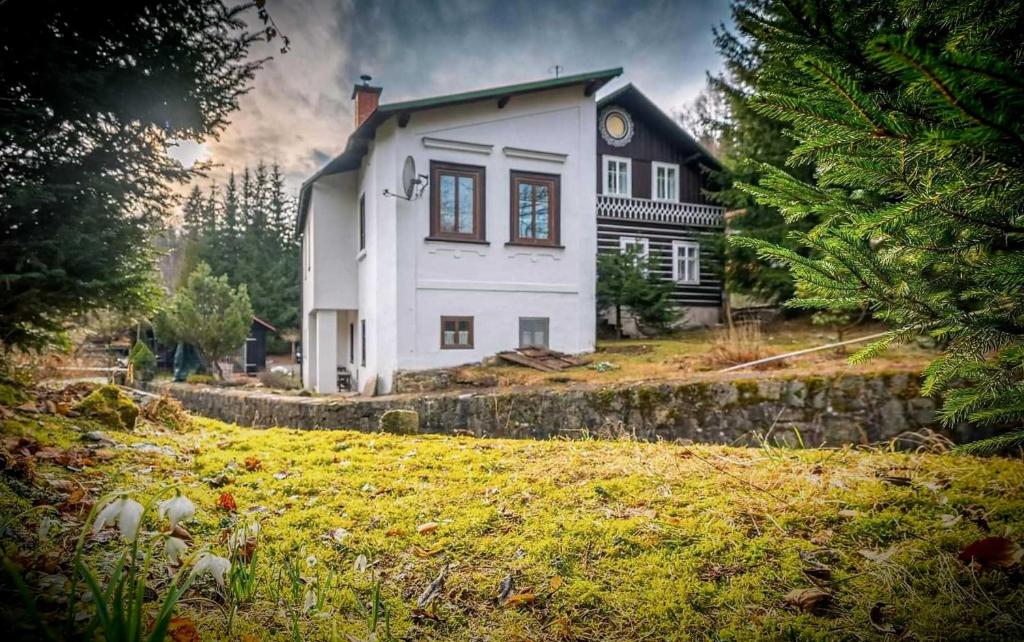 a large white house on a hill with a yard at Chata Amálka in Rokytnice nad Jizerou