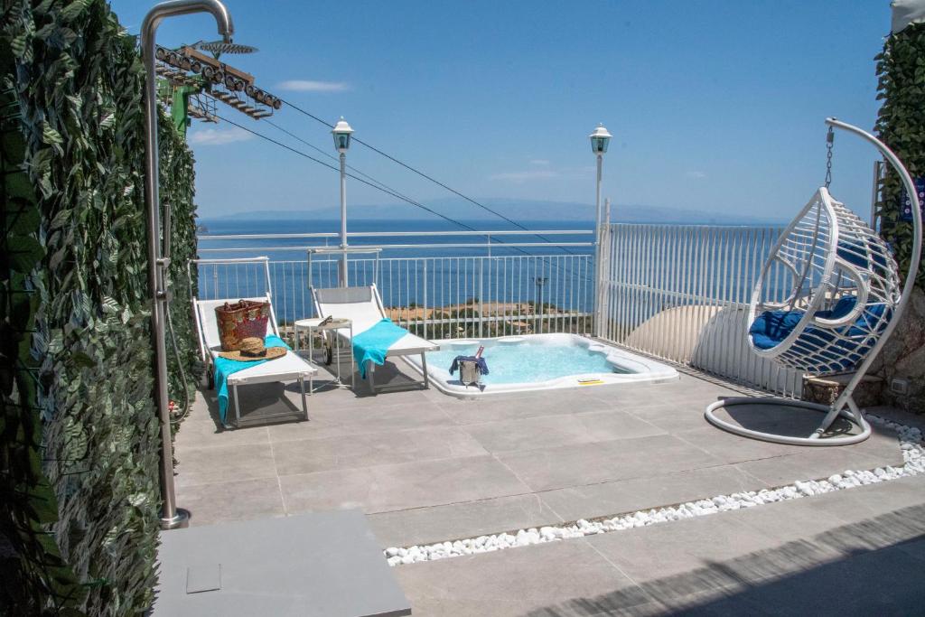 a patio with a pool and a swing at Dream View Suites Taormina in Taormina