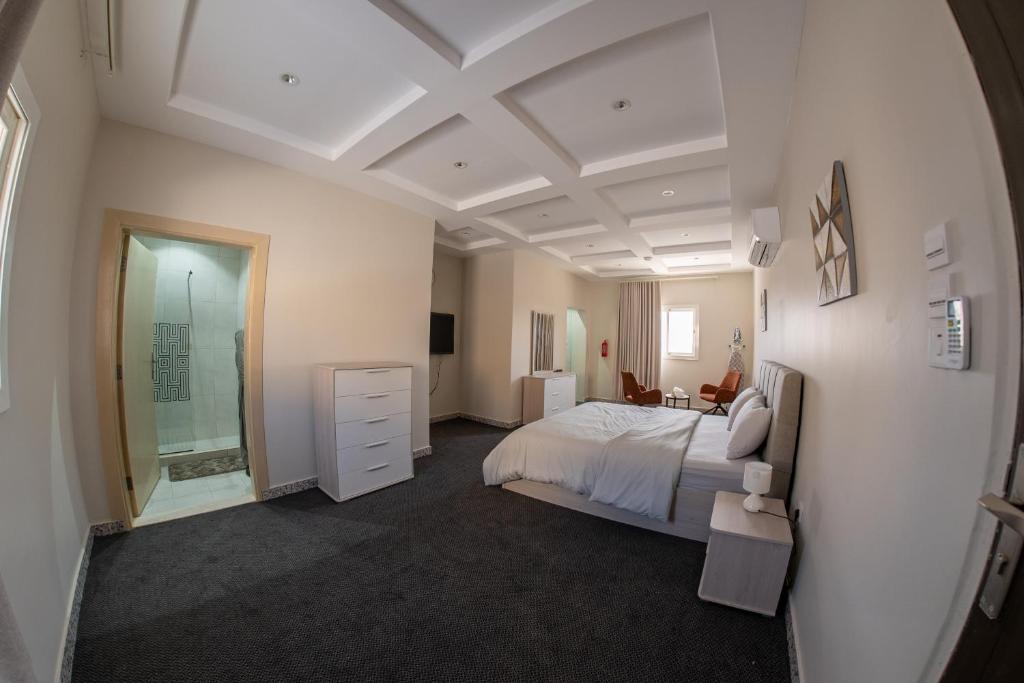 a bedroom with a bed and a walk in shower at The view apartment -studio 1 in Al Baha