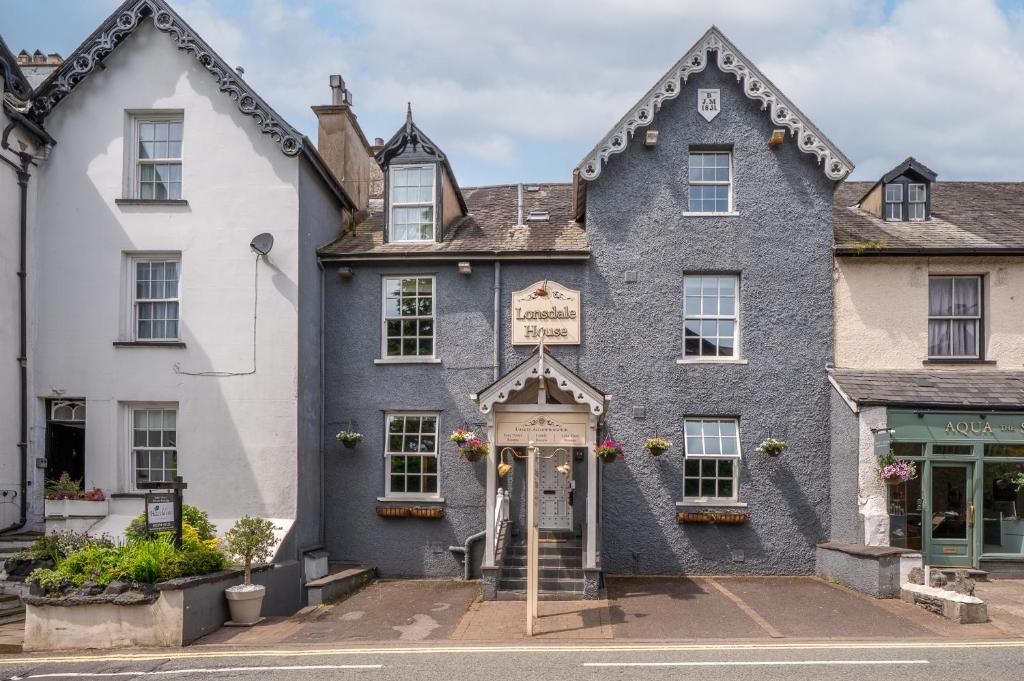 a blue building with a sign over the door at Lonsdale House in Bowness-on-Windermere