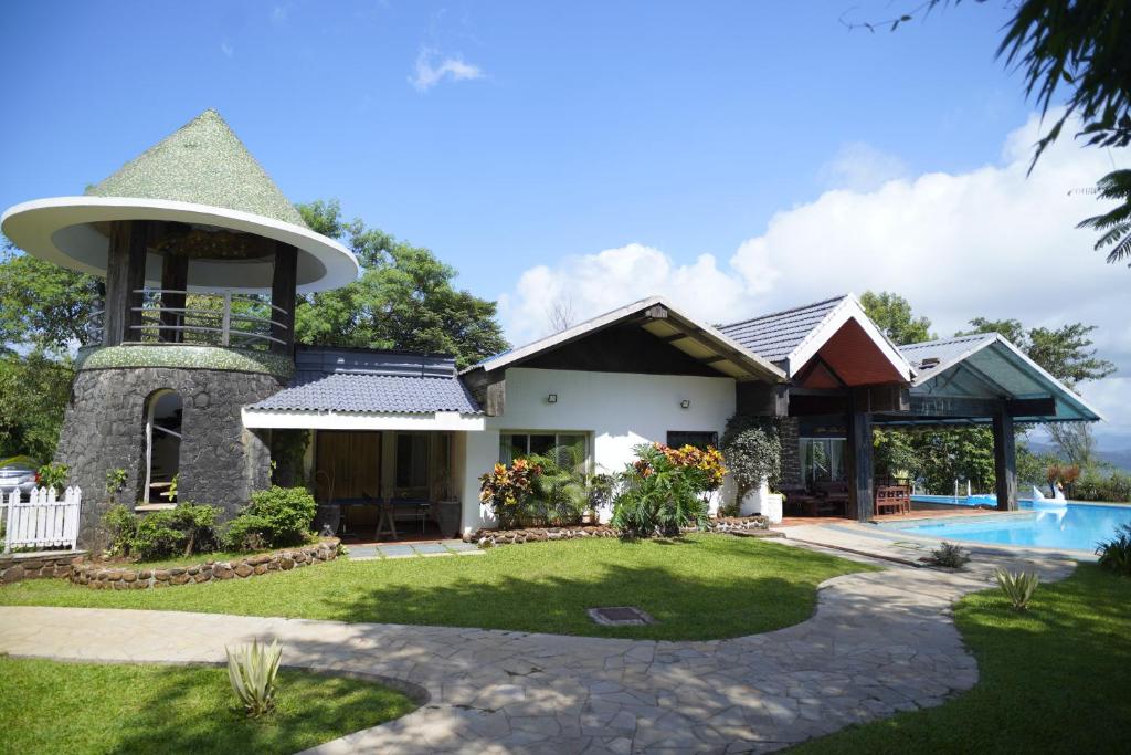 a house with a turret and a swimming pool at White Castle in Malavli