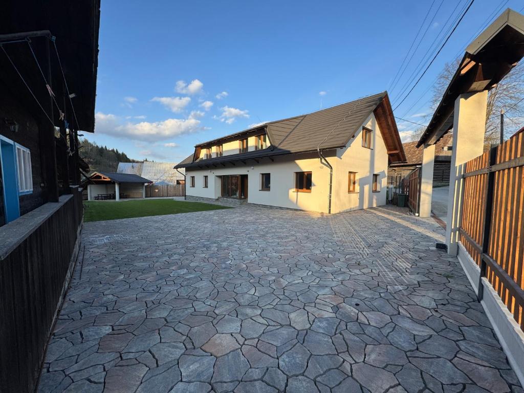 a stone driveway in front of a house at Pallov Dvor in Lutiše