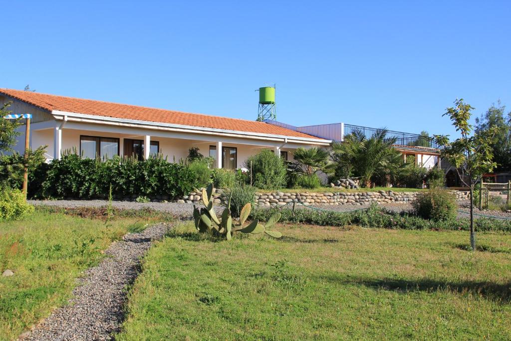 a house with a garden in front of it at La Maravilla Lodge in Vilches