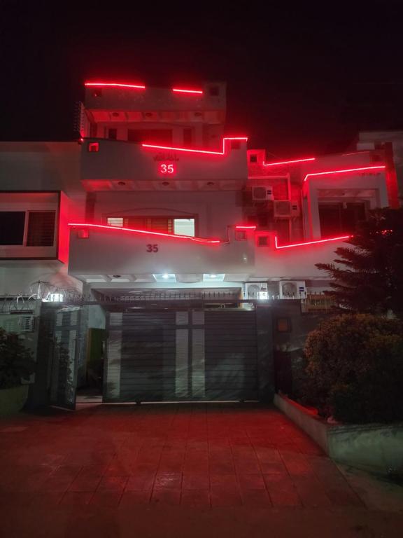a building with red lights on it at night at INTOWN Hotel in Islamabad
