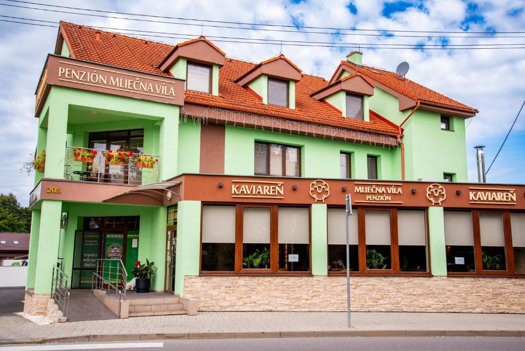 a green building with a red roof at Mliečna víla in Turčianske Teplice