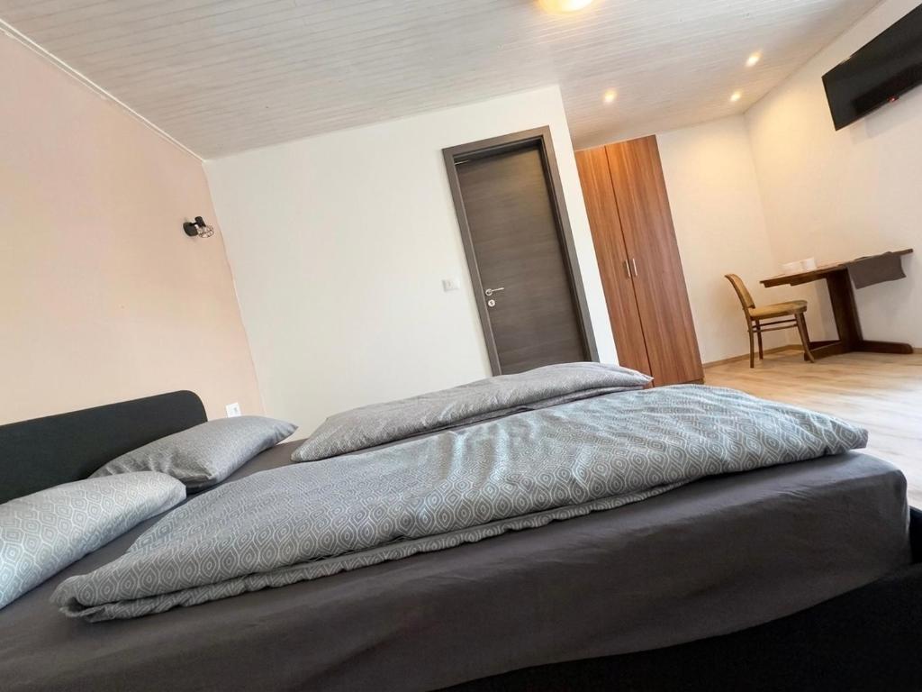 a large bed with pillows on it in a bedroom at Danilo Room 1 in Pula