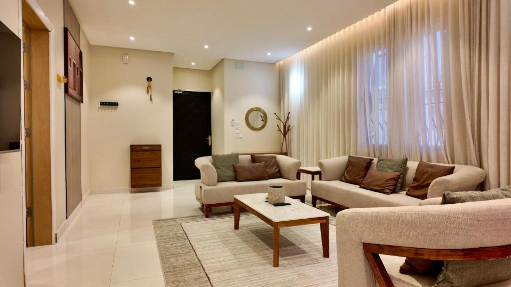 a living room with two couches and a table at نزل ليلى الفندقية الفاخرة luxury in Abha
