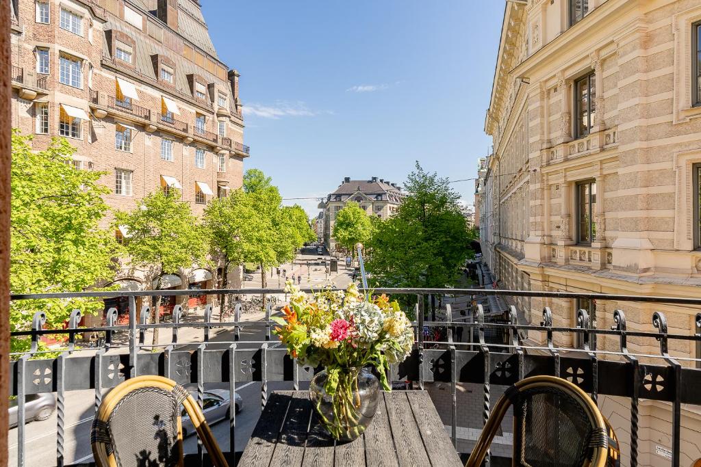 a table with a vase of flowers on a balcony at Crystal Plaza Hotel in Stockholm