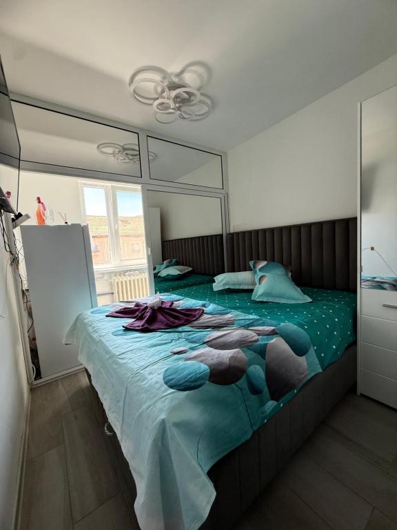 a bedroom with a large bed with a mirror at Luxury Apartament in Bacău