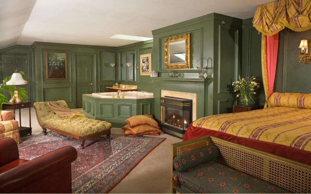 ein Schlafzimmer mit einem Bett, einem Waschbecken und einem Kamin in der Unterkunft Hydrangea House Inn in Newport