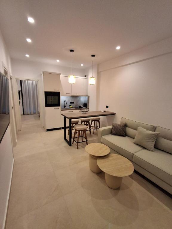 a living room with a couch and a table at Salsedo Seaside Rooms in Kanali