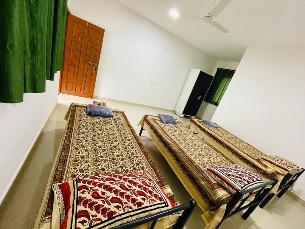 a room with three racks of carpets on the floor at Vaidic Yoga Retreat in Ponsuli