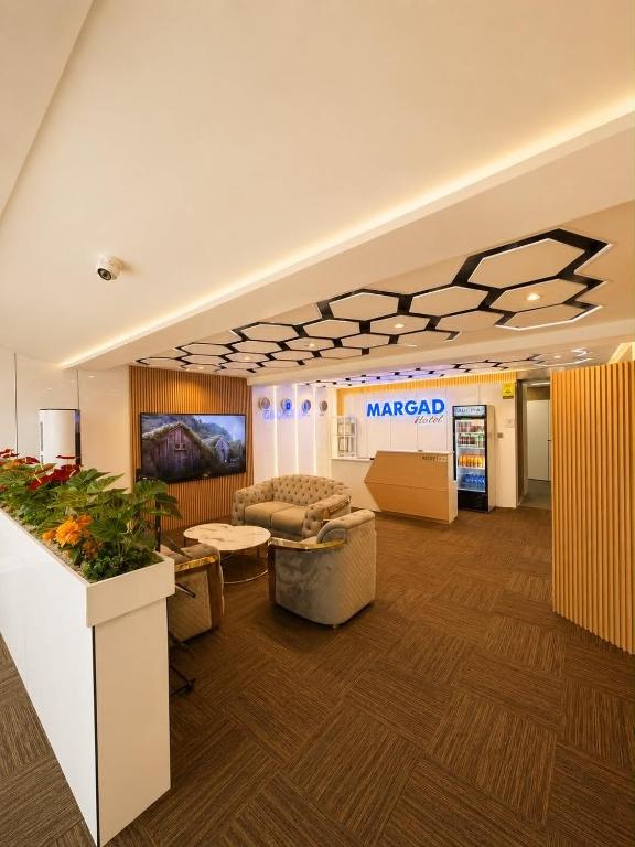 a lobby with a martacist sign on the wall at Margad Hotel in Ulaanbaatar