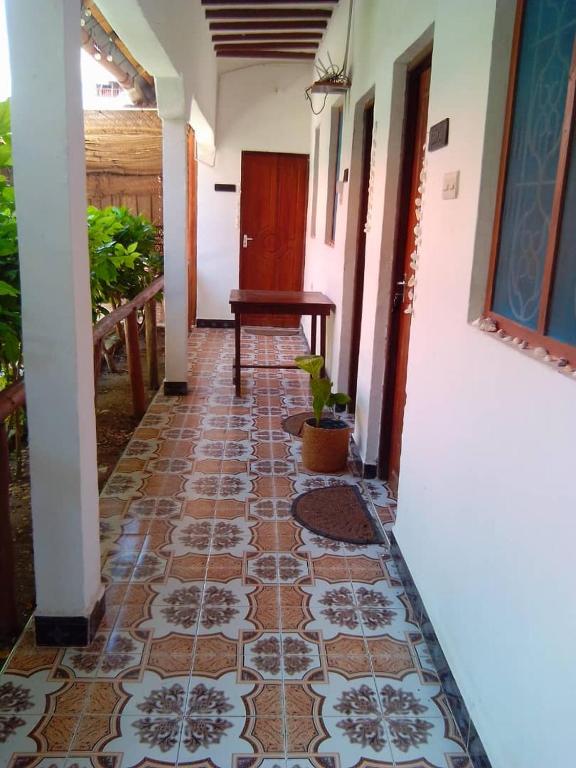 a hallway of a house with a tile floor at Arham Nungwi Beach in Nungwi