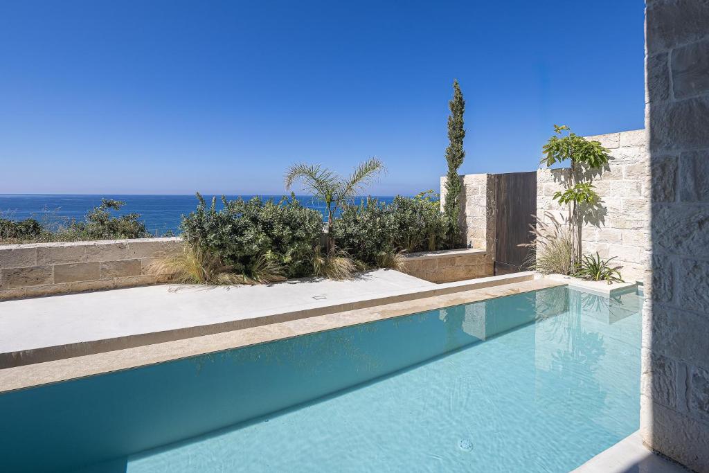 a swimming pool with a view of the ocean at My Cave Blue Iconic Designer Villa by etouri in Rethymno