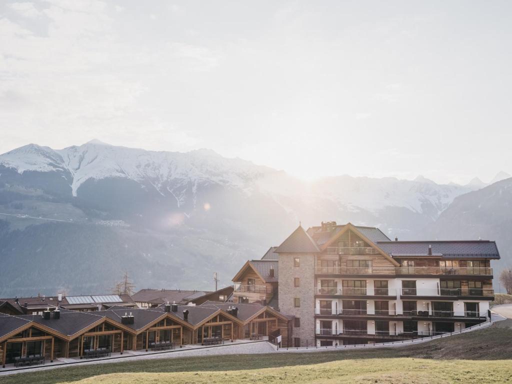 a large building with mountains in the background at VAYA Ladis in Ladis