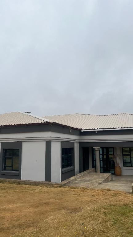 a large building with a large garage at Solomon Guest House in Maseru