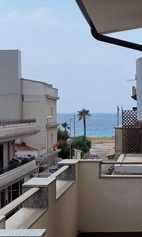 a view of the ocean from the balcony of a building at Una Terrazza sul mare in San Ferdinando