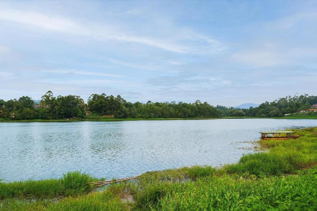 a boat is sitting on a large lake at Cozzy Villa TB & Outbond in Riunggunung