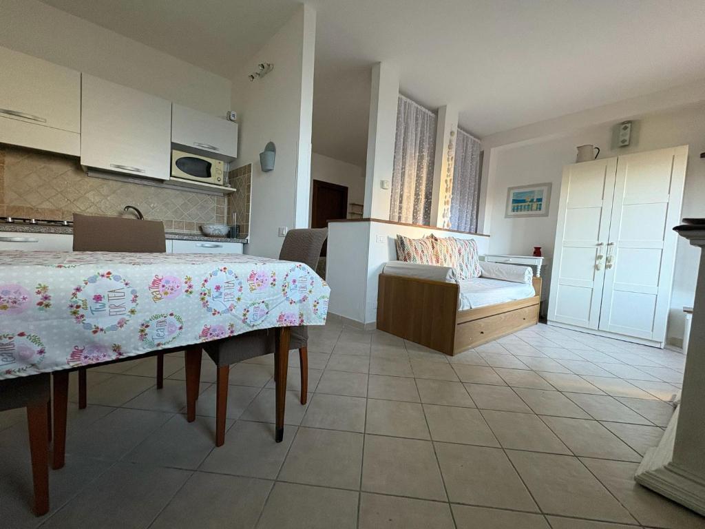 a kitchen and living room with a table and a couch at Alloggio turistico La casetta di Piazza Roma in Bracciano