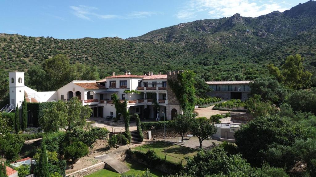 an aerial view of a building with mountains in the background at Mas Cusi in Palau-Saverdera