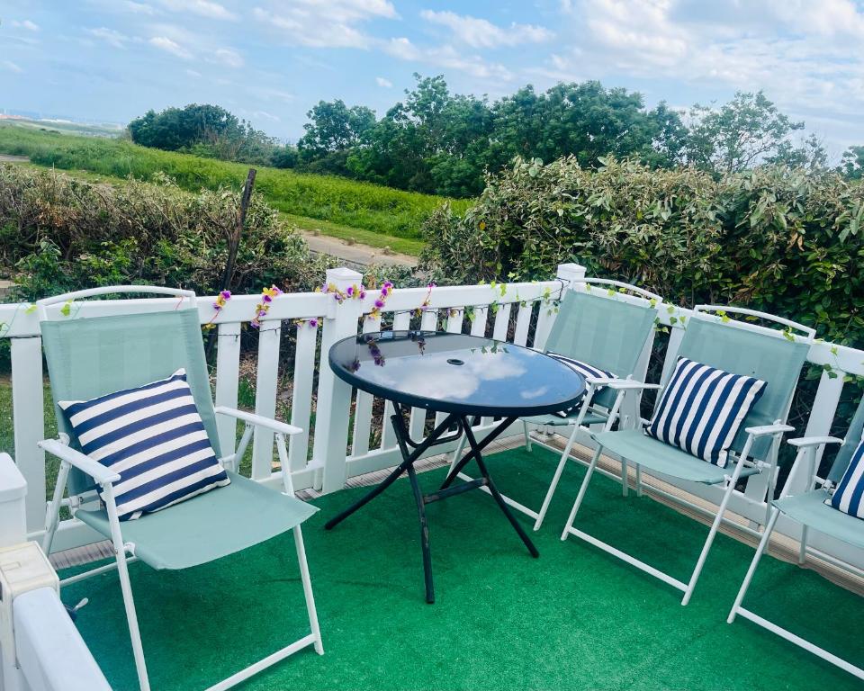 two chairs and a table on a patio at Woodlands Dene - Crimdon Dene Holiday Park - Accessible in Hartlepool