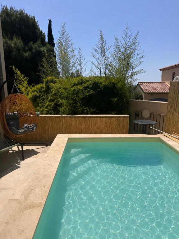 a swimming pool in the backyard of a house at Maison village provençal in Éguilles