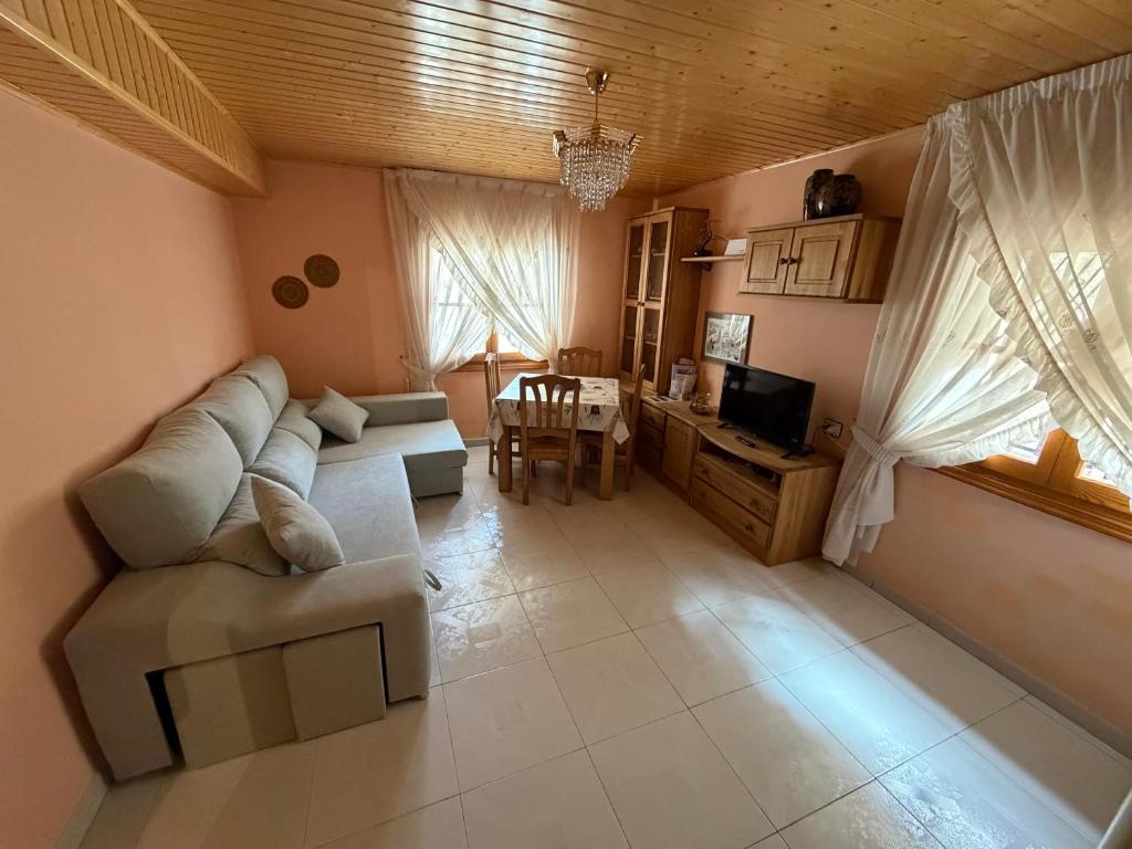 a living room with a couch and a table at Apartamento Berro in Guadalaviar
