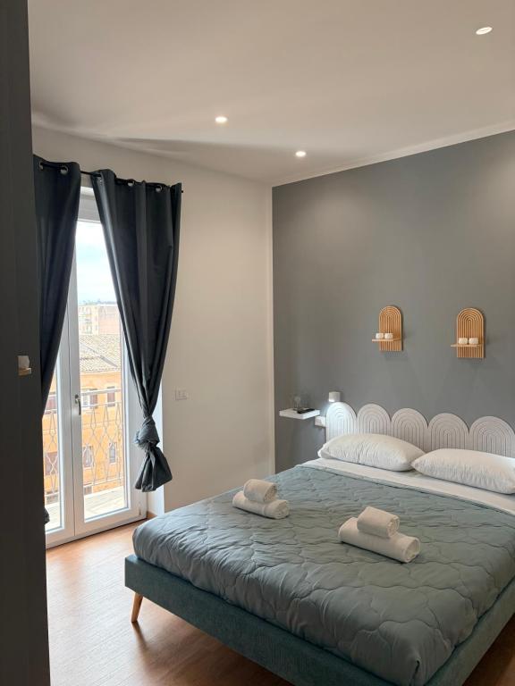 a bedroom with a bed with two towels on it at Eirenè Peaceful Suites in Agrigento