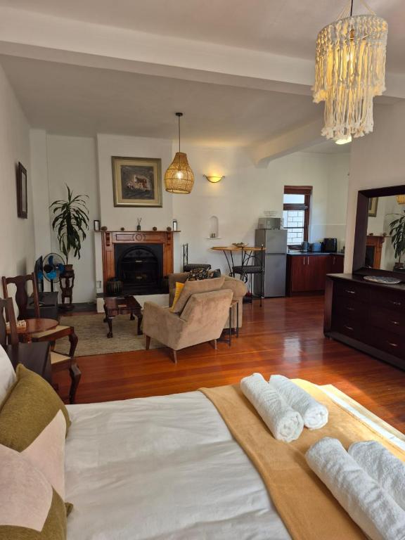 a living room with two beds and a living room at Open plan apartment in Muizenberg in Muizenberg
