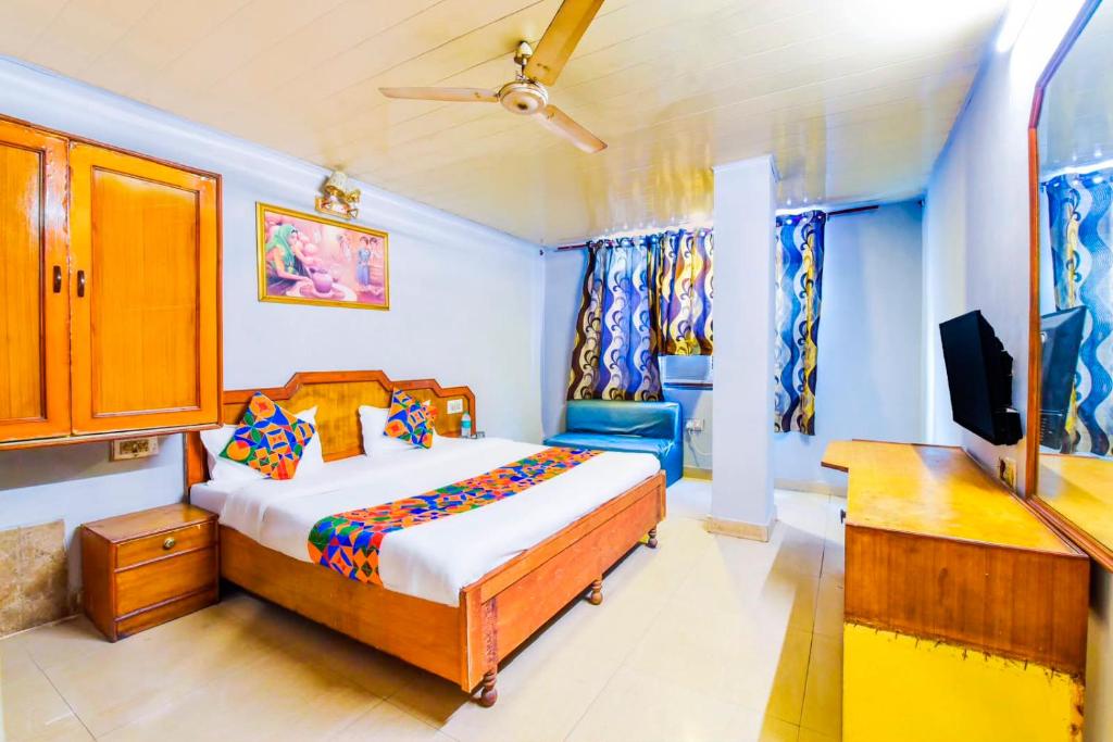 a bedroom with a bed and a flat screen tv at Hotel Shaan- M I Road City Centre in Jaipur