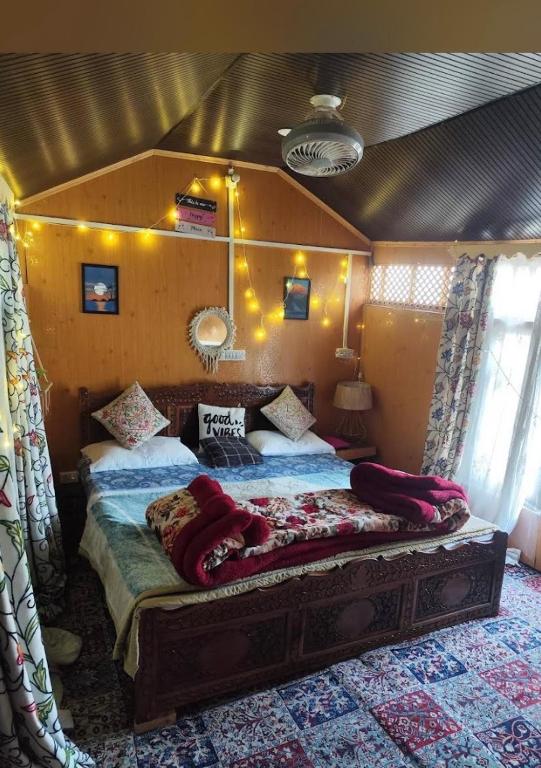 a bedroom with a large bed in a room at Blackpearl in Srinagar