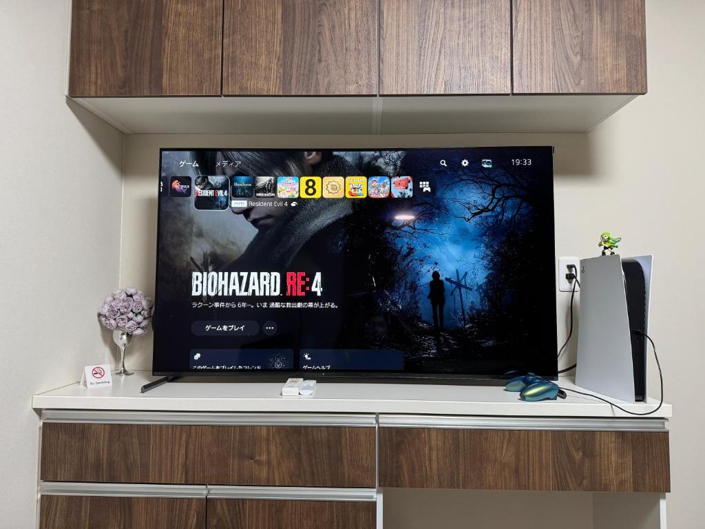a flat screen tv sitting on top of a cabinet at The GameStop in Osaka