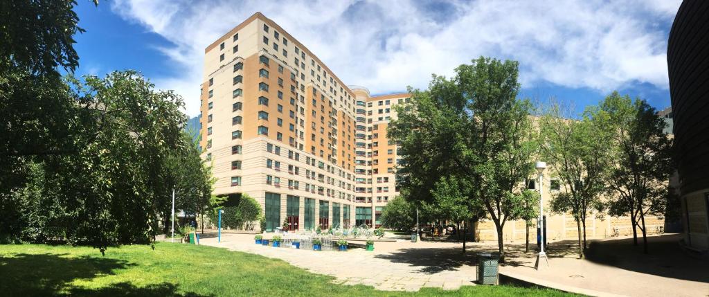 ein großes Gebäude mit einem Park davor in der Unterkunft Toronto Metropolitan University- Pitman Hall Residence in Toronto