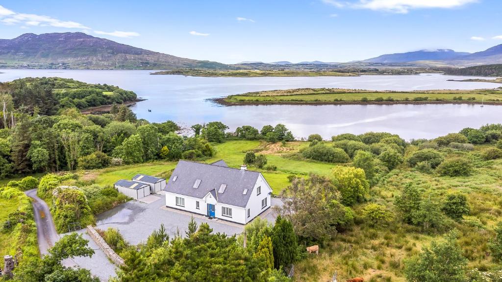 an aerial view of a house on the shore of a lake at Connemara Bay House in Moyard
