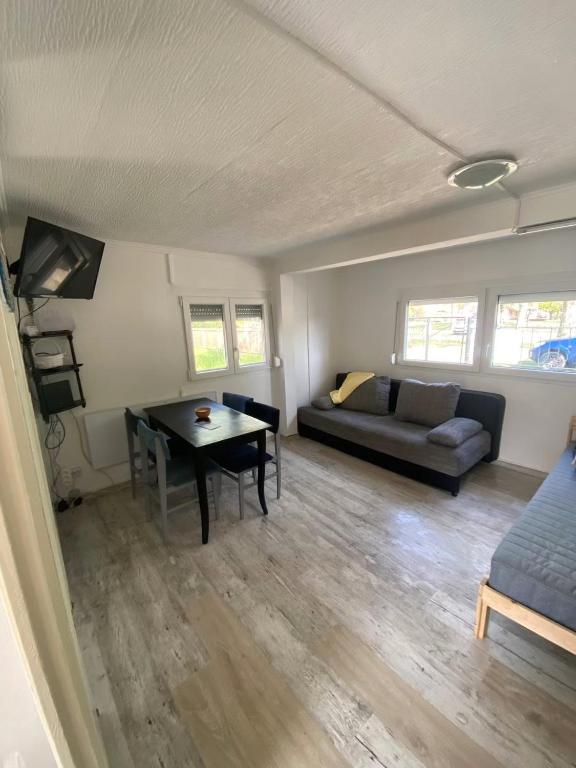 a living room with a couch and a table at KissKovács Lak in Cserkeszőlő