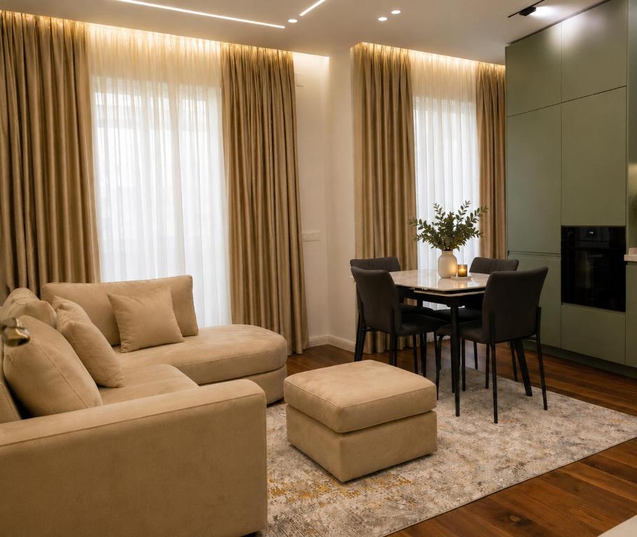 a living room with a couch and a table at Dream Luxury Suite in Tirana