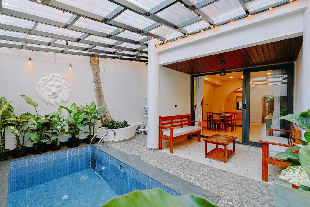 a house with a swimming pool and a patio at Tiadoro Villa in Calangute