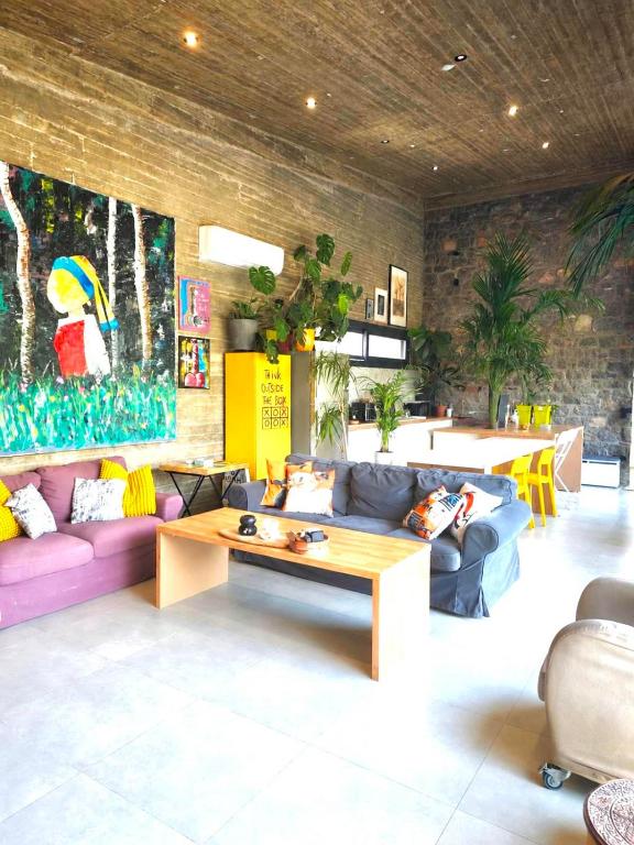 a living room with couches and a coffee table at Casa del Quadro in Chios