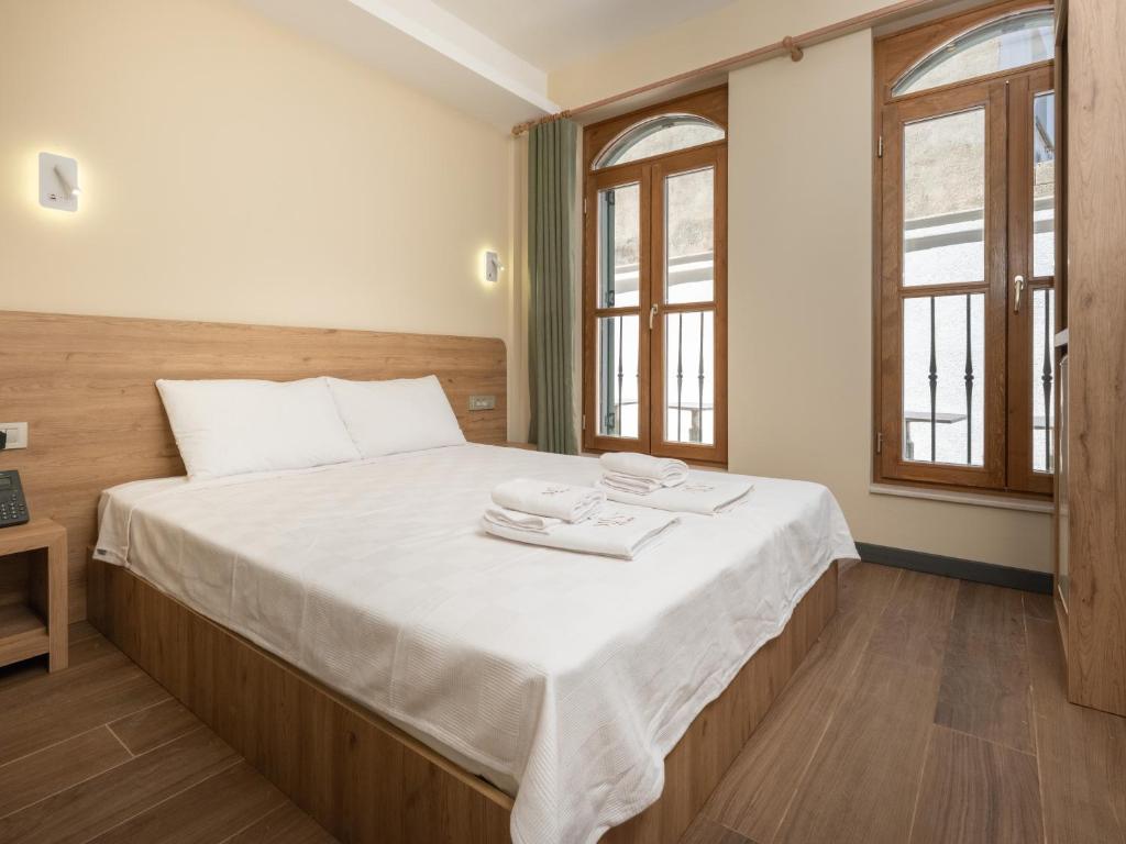 a bedroom with a bed with two towels on it at The Mint Urla in Kuscular