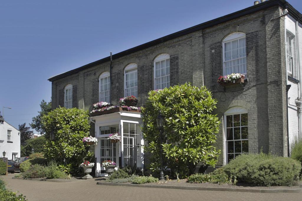 a brick building with flower boxes on the windows at Best Western Annesley House Hotel in Norwich