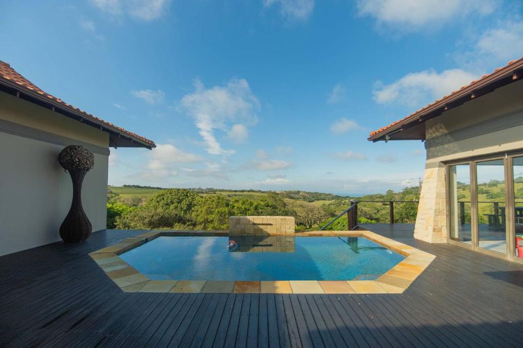 a swimming pool on the deck of a house at Bevuline in Gqeberha