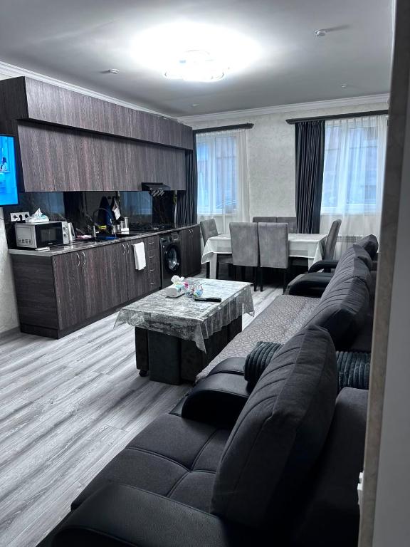 a living room with a couch and a table at Jermuk Cozy Apartment in Jermuk