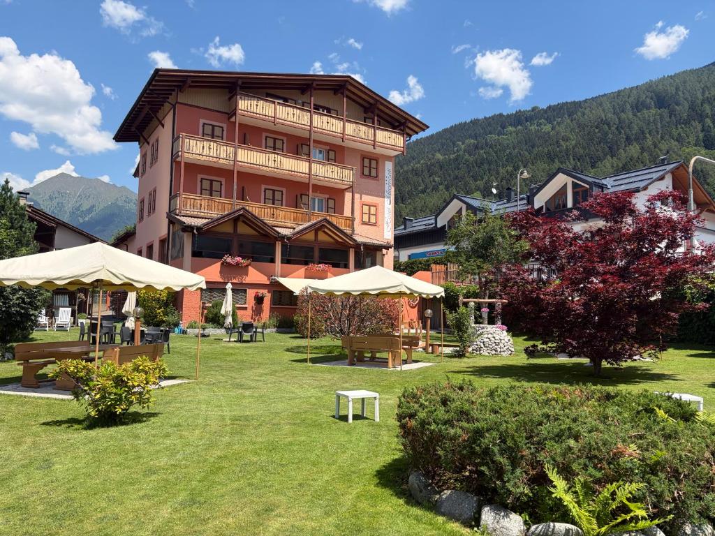 a large building in the middle of a park at Hotel Miramonti in Pinzolo